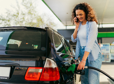 woman putting gas in car